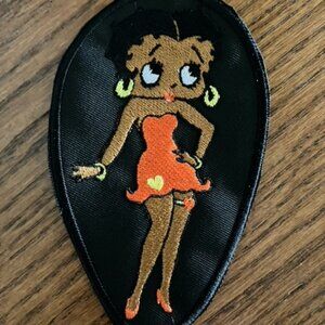 Black Betty Boop embroidered patch donning usual skimpy orange dress and shoes